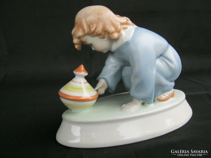 Zsolnay is a little boy playing with a porcelain whistle