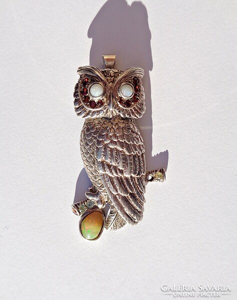 Silver pendant with many stones, patterned with an owl