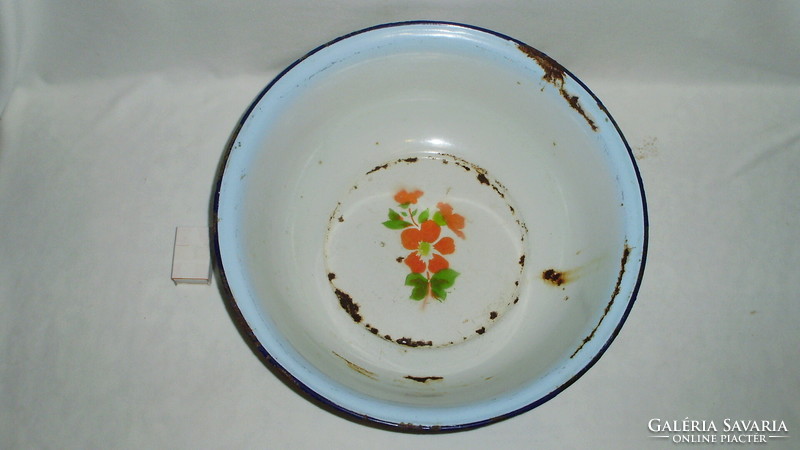 Old, flowery, pale blue edged enamel bowl marked 