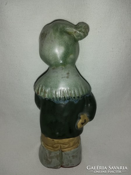 Fired glazed ceramic figurine of a small child in a hat