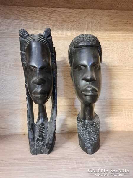 Black, ebony colored, polished female and male native head sculptures