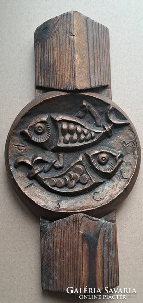 Fish, metal craftsman's work on a wooden column.