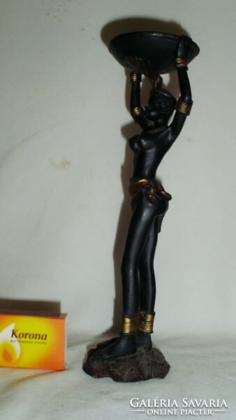 African woman figure holding a candle or candlestick