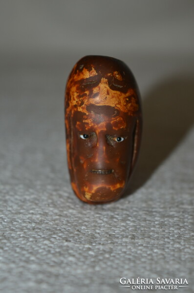 Carved head cap with glass eyes