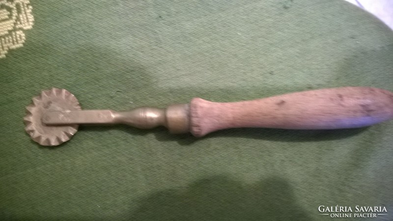 Old copper wood cutter with wooden handle - peaceful, solid piece.