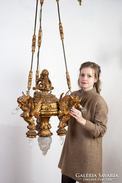 Gilded wooden chandelier - with plastic lion heads