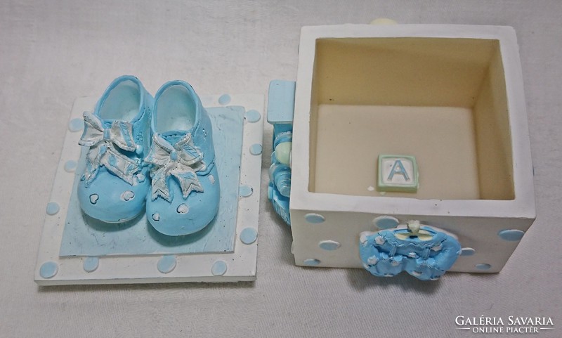 Bright baby blue shoes with a box hiding the letter. A beautiful gift for baby visits.