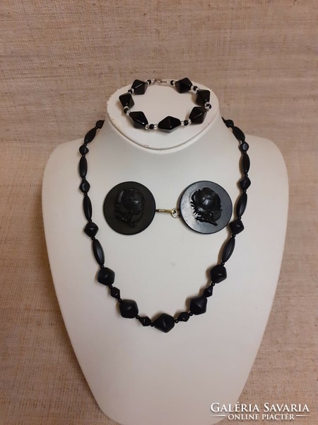 A necklace bracelet made of old black porcelain beads and a belt buckle embossed with a rose pattern for mourning