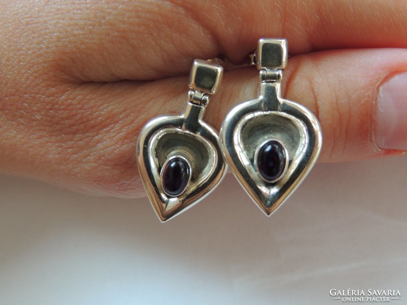 Unique designed silver earrings decorated with amethyst stone