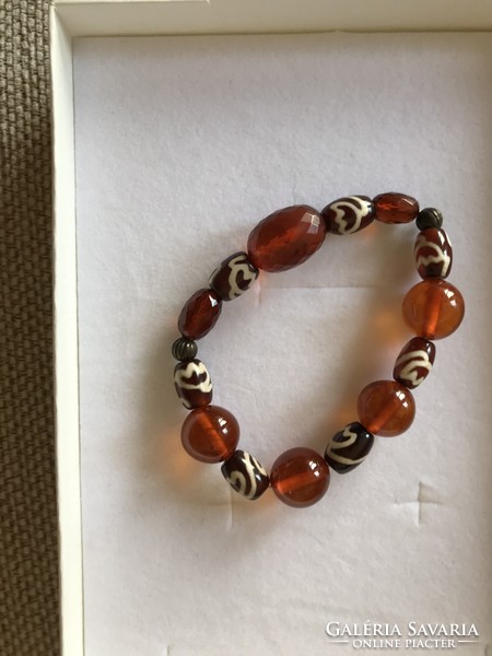 Amber bracelet strung on rubber with glass beads