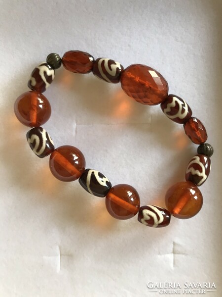 Amber bracelet strung on rubber with glass beads