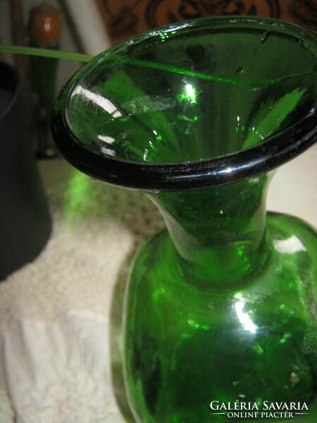 Giant spherical vintage 1 l green bottle with cork