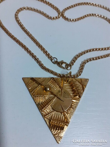 Marked applied arts gilt relief bronze triangle pendant on a gilt thick long chain