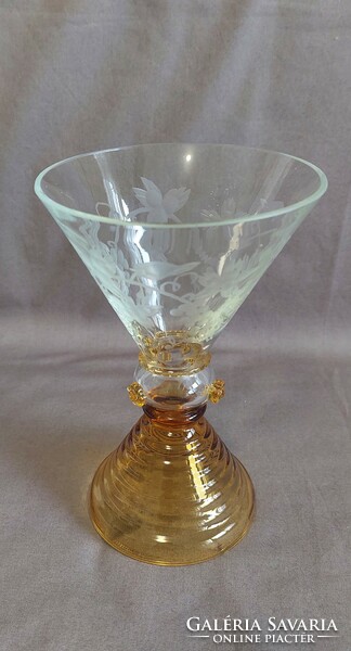 It has a special shape and color. The chalice part of the glass has a polished grape motif!