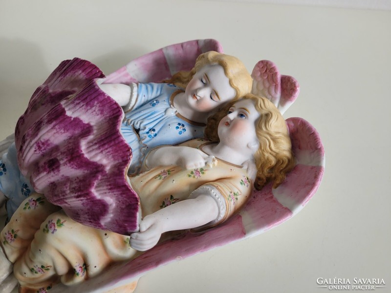 Old biscuit porcelain angels holding a large wall holy water container