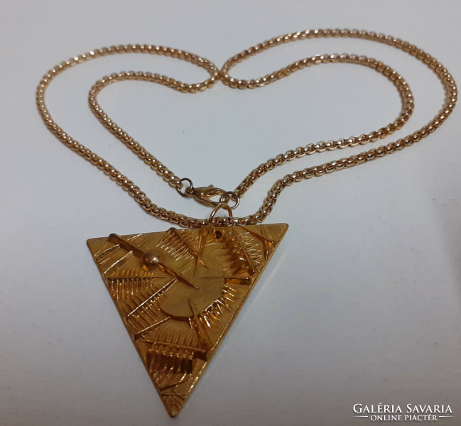 Marked applied arts gilt relief bronze triangle pendant on a gilt thick long chain