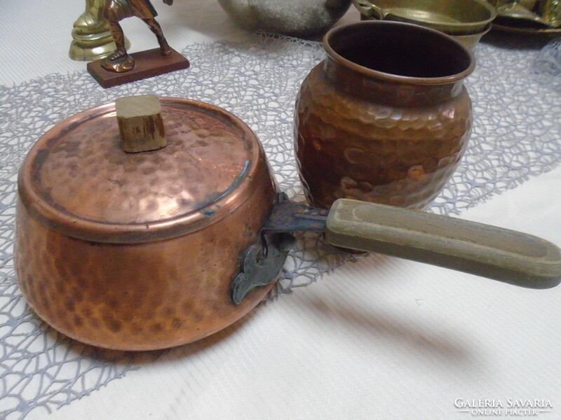 An old copper teapot with a handle and a vase, both with markings, in perfect condition