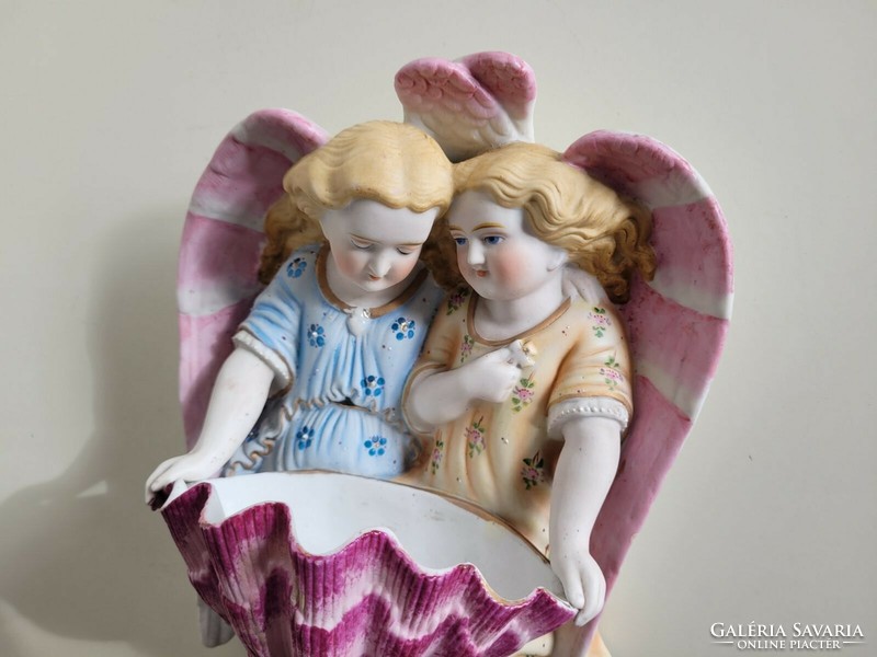 Old biscuit porcelain angels holding a large wall holy water container