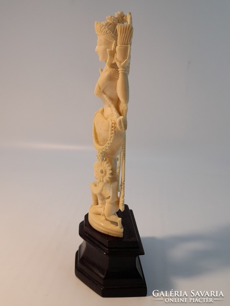 Far Eastern bone statue on a wooden pedestal