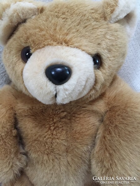 Teddy bear with medium brown, silky fur, opening pocket at the back