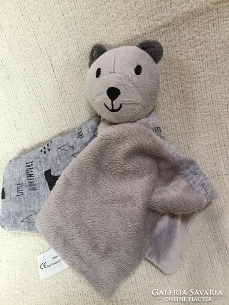 A light gray teddy bear or a doggy cuddly toy