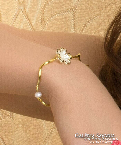 Gold bracelet, with white flower, opal white crystals, gold twisted metal elements. Kkel.