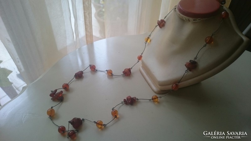Silver necklace decorated with amber