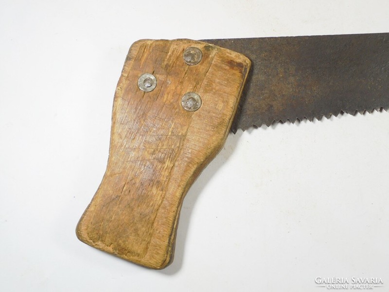 Old handsaw wooden saw riveted, wooden handle