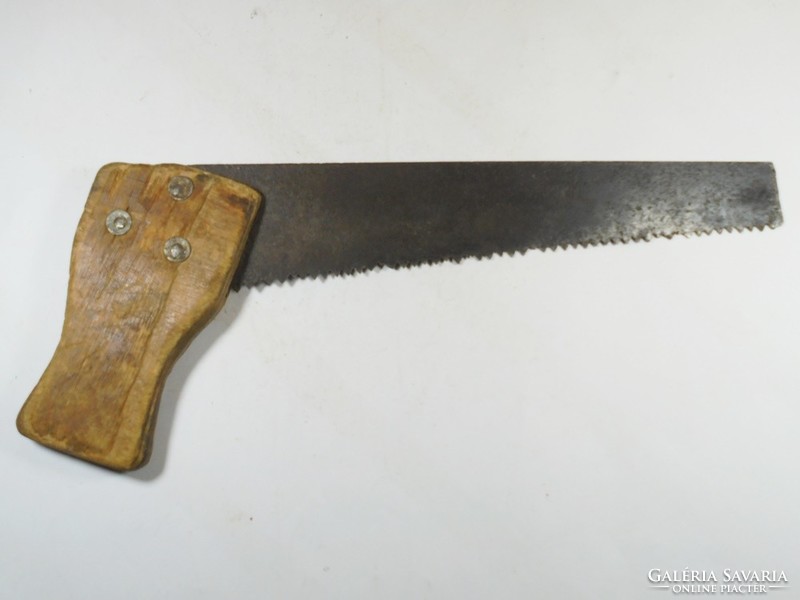Old handsaw wooden saw riveted, wooden handle