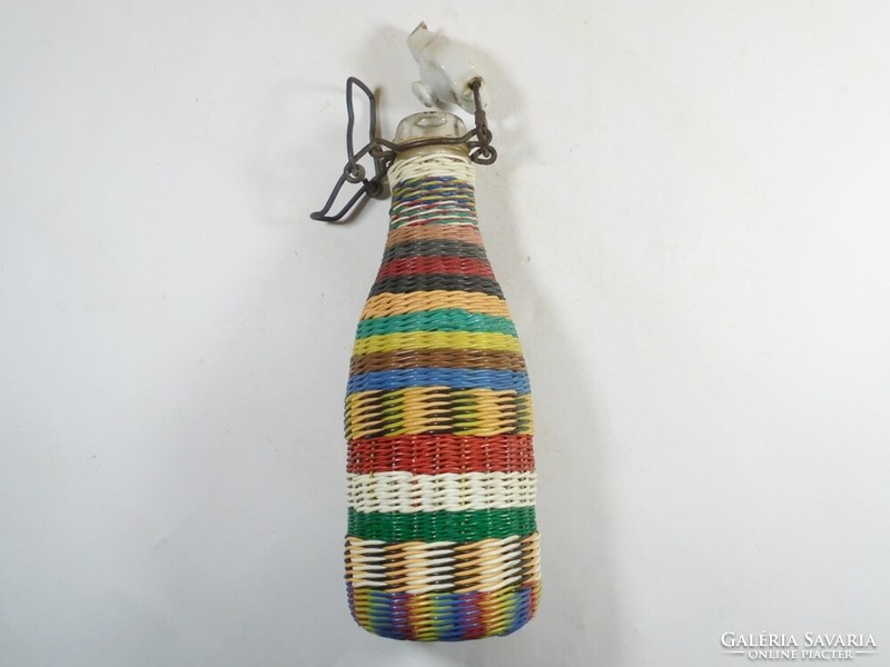 A small glass bottle with a retro wire braided demizon-like buckle