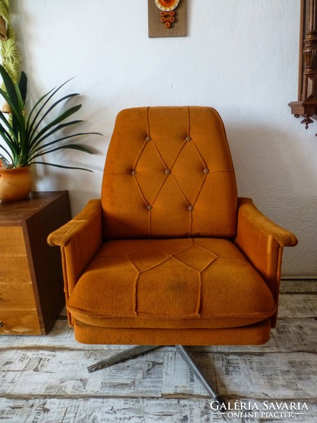 Retro, dark orange swivel armchair