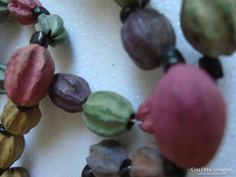 Pastel necklace made of plant seeds.