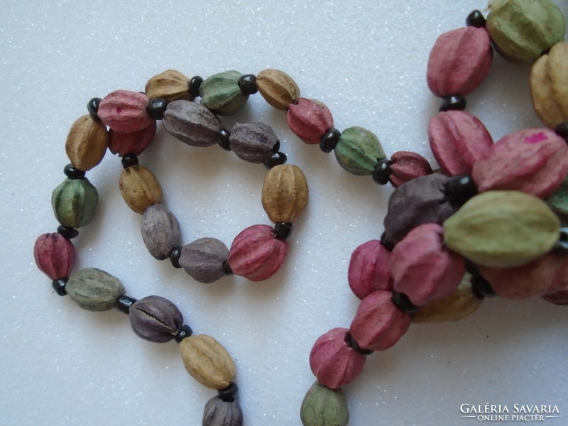 Pastel necklace made of plant seeds.