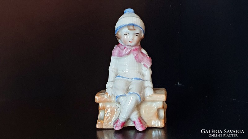 Rare, antique, German, small porcelain. Sitting child in winter clothes. 9 cm high.