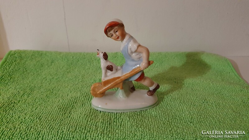 Old German mini porcelain figure. Wheelbarrow lad with dog. 8 Cm.