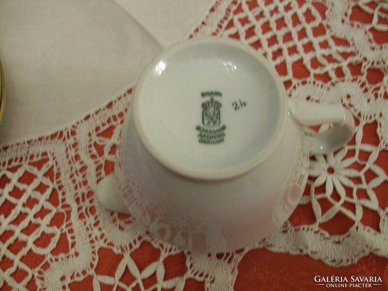 Porcelain teapot with a beautiful golden border, on a snow-white base, sugar holder and milk spout