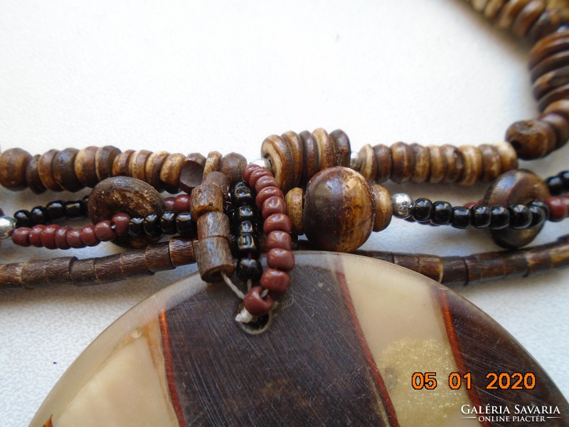 3-row necklace with brown shades of mistletoe beads with a large wood and bone layered pendant