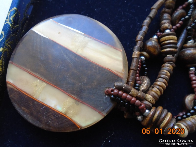 3-row necklace with brown shades of mistletoe beads with a large wood and bone layered pendant