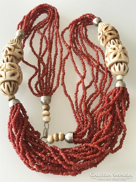 Necklace made of carved bone eyes and coral beads, 74 cm long