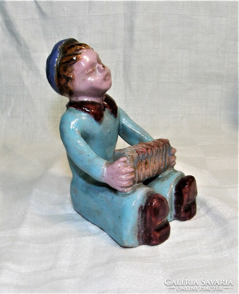 Ceramic figurine of a boy with an accordion