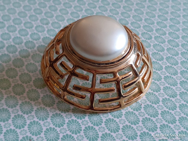 Retro metal brooch with old female badge