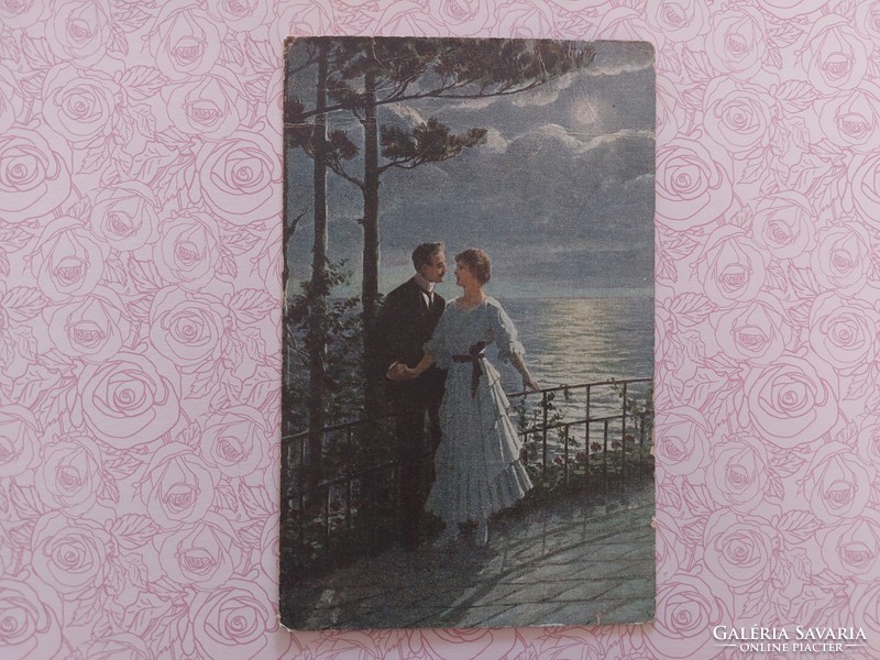 Romantic couple with old postcard1918 postcard