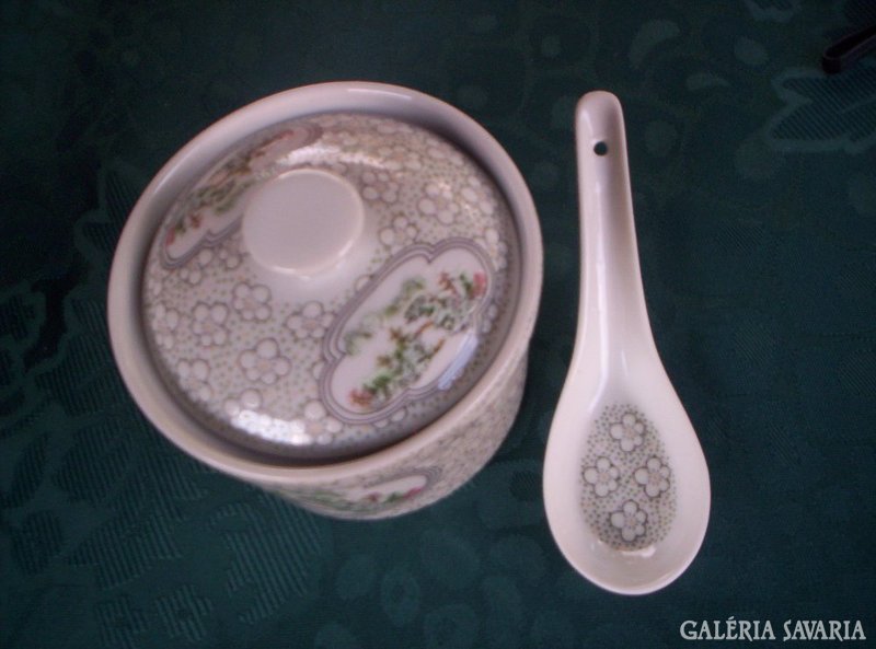 With a small porcelain spoon with a lid. X