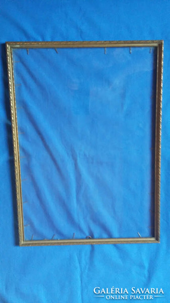 Old, gold-colored, glass, thin picture frame