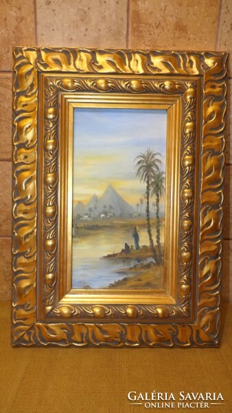 A painting depicting an Egyptian landscape in a beautiful frame