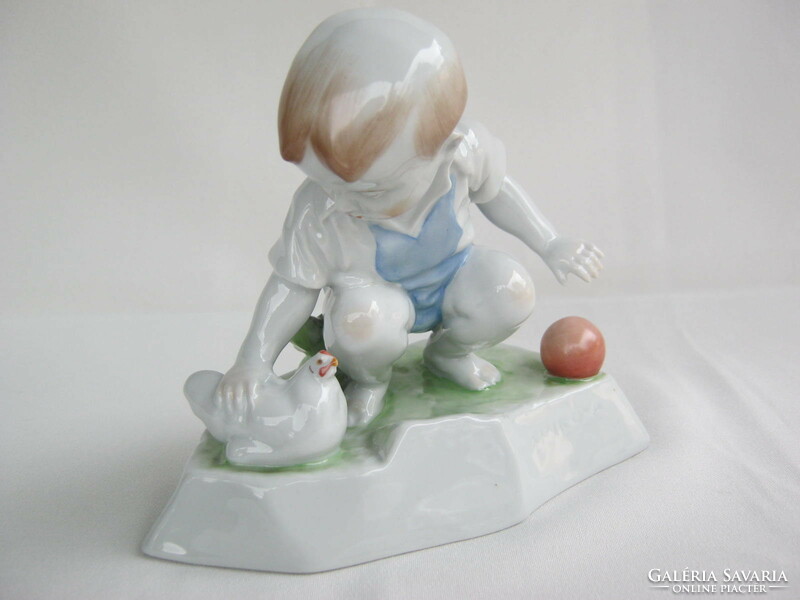 Little boy stroking Zsolnay porcelain hen