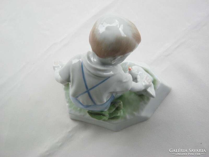 Little boy stroking Zsolnay porcelain hen