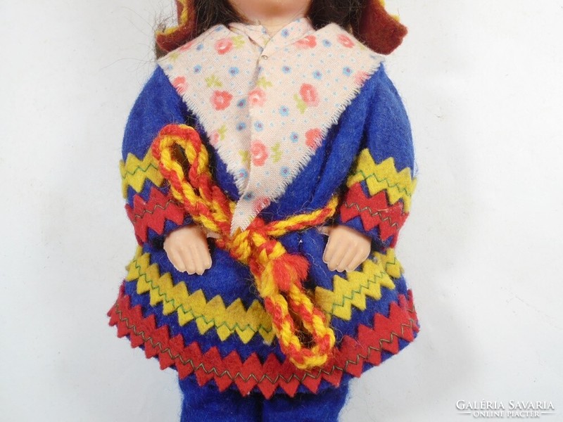 Retro old toy plastic doll in traditional clothes