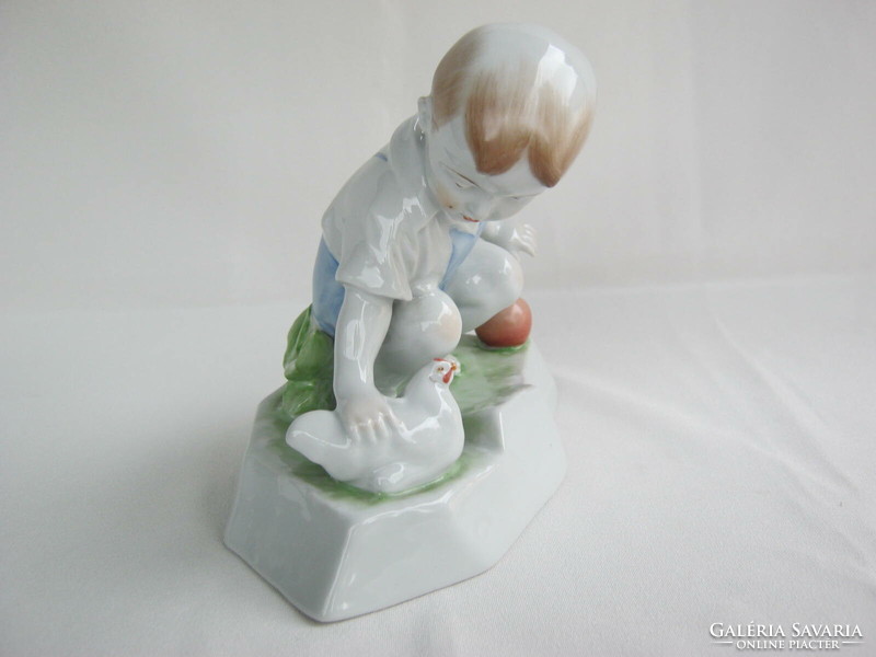 Little boy stroking Zsolnay porcelain hen