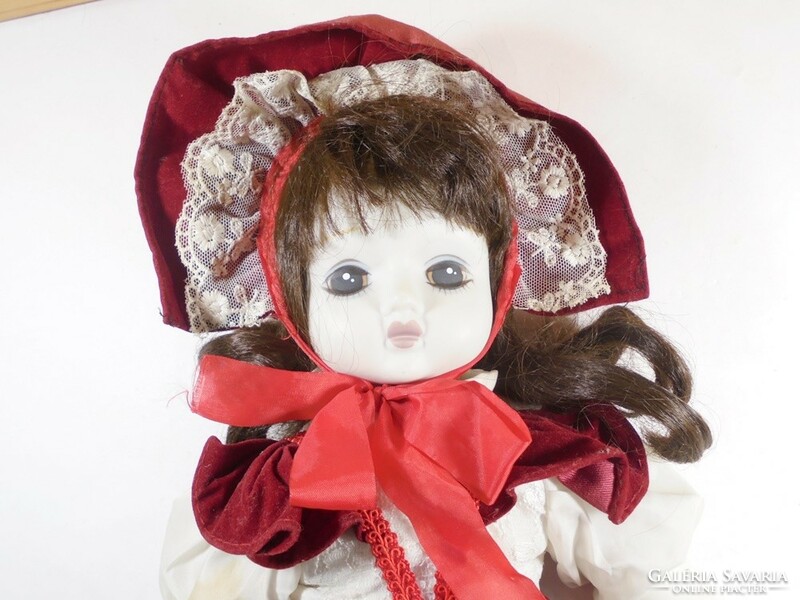 Retro old toy porcelain doll in a celebratory ball gown
